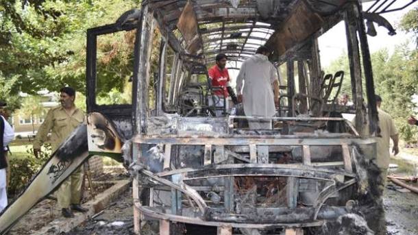 A scene of the charred bus which was completely destroyed in bomb blasts in Quetta