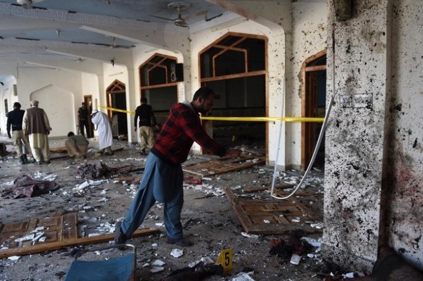 Pakistani security personnel inspect the mosque following the attack. A Majeed/AFP / Getty Images